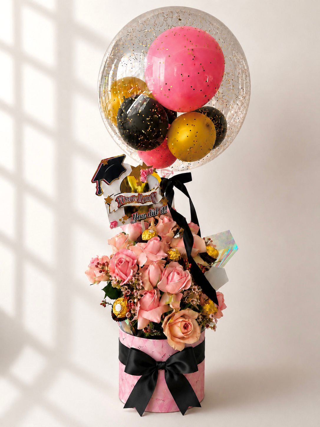 Graduation floral balloon arrangement by Golden Script Co.